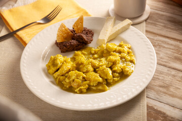 Scrambled eggs in green sauce. A typical Mexican breakfast of scrambled eggs tossed in spicy green sauce, usually accompanied by beans and pot coffee.