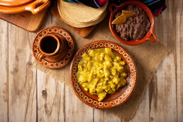 Scrambled eggs in green sauce. A typical Mexican breakfast of scrambled eggs tossed in spicy green sauce, usually accompanied by beans and pot coffee.