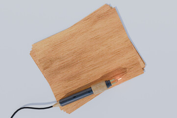 wooden board with burning pen tool for pyrography mock up
