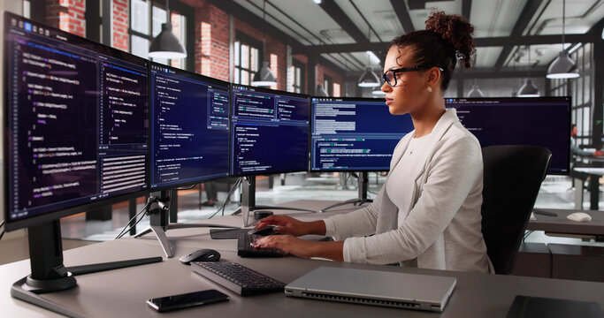 Fototapeta Portrait Of Young Black Female Software Engineer Coding