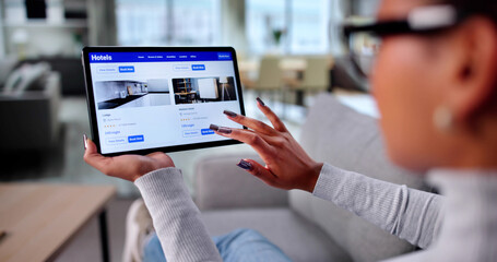 Businesswoman Using Tablet To Book Hotel Online And Search