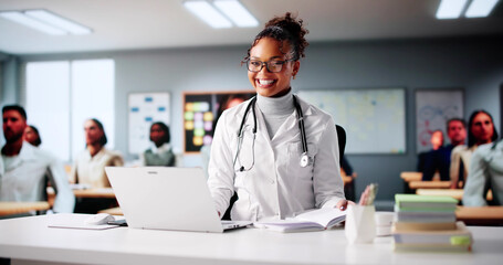 Young African American Woman Studying With Laptop In College Classroom