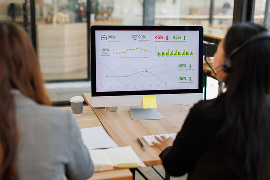 Diverse group of people work at call center or helpful customer service. Attractive women uses pc computer and monitor at busy agency office closeup. Phone talk and answer questions on modern hotline
