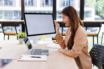 Obraz premium Talking, happy asian woman and customer service in call center with headset, communication and online consulting. Smile, friendly consultant and sales office CRM contact support, advice or business 