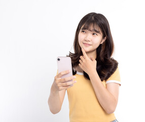 Happy Young woman thinking and holding the smart phone