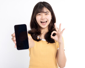 Asian girl showing or presenting mobile phone application and ok sign isolated over white background