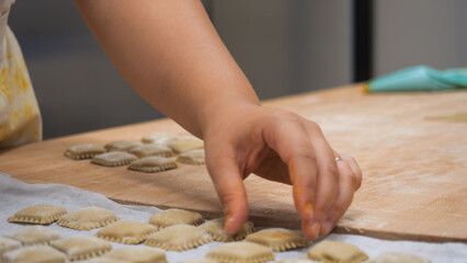 Passionate Chef Meticulously Crafts Handmade Ravioli with Focused Precision in a Cozy Small Business Italian Kitchen