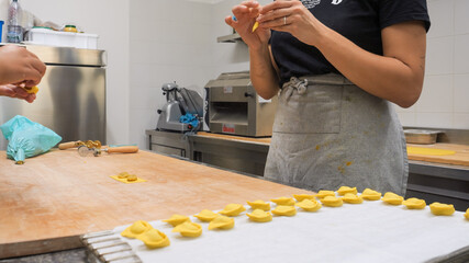 Artisan Hands Crafting Delicious Tortellini Pasta With Passion In A Small Italian Food Business Kitchen Close Up Focus