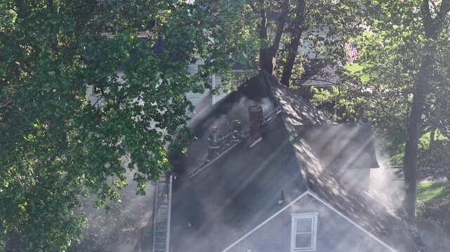 Firefighters Working on the Roof of a Burning House