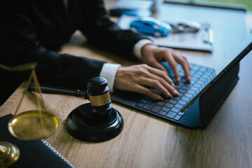 Lawyer’s desk with gavel, contract, and toy car symbolizing justice, legal judgment, insurance claim, and automobile law cases.