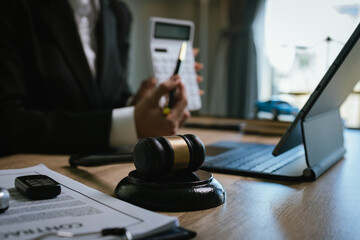 Lawyer’s desk with gavel, contract, and toy car symbolizing justice, legal judgment, insurance...