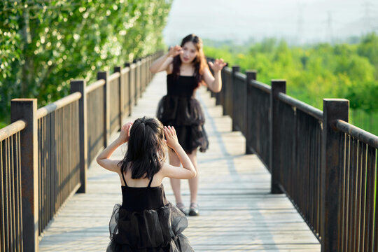 Asian mother and daughter traveling and having fun in outdoor park in summer