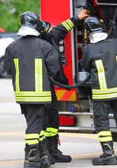 Naklejka premium firefighters during an emergency situation and the fire truck