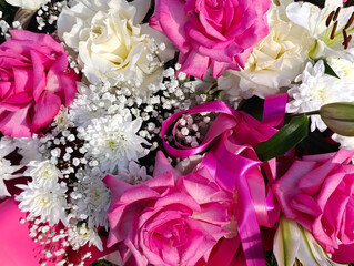 Festive backdrop of white and pink flowers and satin ribbons