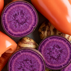 
Macro Close-Up of Sliced Purple Ube Yam and Pile of Pink-Purple Sweet Peppers – Vivid Root Vegetable Texture.close up of a pile of pink and purple sweet pepper, Macro shot of sliced purple ube yam 