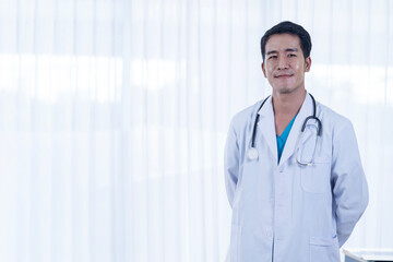 Young Asian man doctor against white background