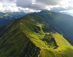 Aerial view of a sunlit green mountain ridge