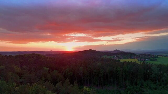 Drone footage captures the sunset over Prachovsk&eacute; sk&aacute;ly, a stunning sandstone rock city within the Bohemian Paradise Česk&yacute; r&aacute;j UNESCO Geopark in the Czech Republic. Golden hour light illuminates the u