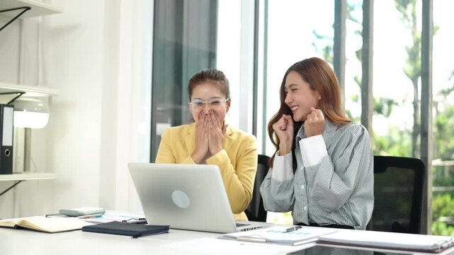 Asian businesswomen managers celebrate project achievement good news triumph collaborative work office partners happy successful professional team