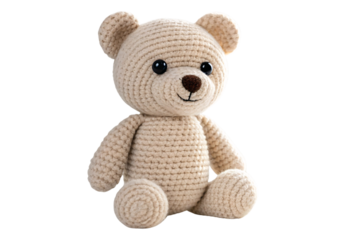 Soft beige crocheted sitting teddy bear with plump body, round limbs, and cheerful embroidered facial expression, isolated on a transparent background