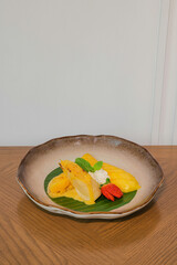 Tropical Delight: An overhead shot showcases the exquisite harmony of yellow mango and sticky rice, all served on a ceramic dish.