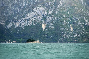 Small island with church and green trees