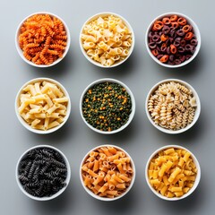Colorful pasta types displayed in bowls culinary showcase indoor setting top-down view food art