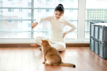 Asian beauty playing with cat at home on holiday