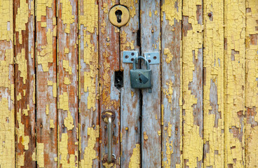 A yellow door with a lock on it