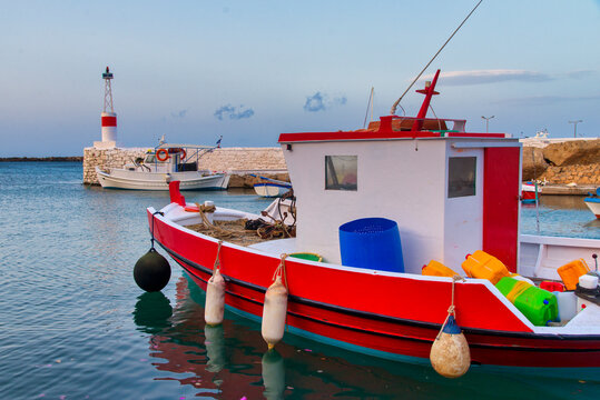 Tranquil Water Scene with Lighthouse and Fishing Boat in Kasos island