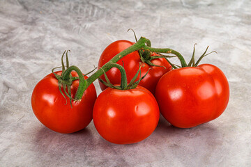 Ripe fresh tomato on the branch