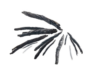 Dry twisted leaves of Kuding tea levitate on a white background