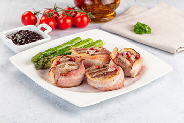 Tasty grilled pork medallion with bacon