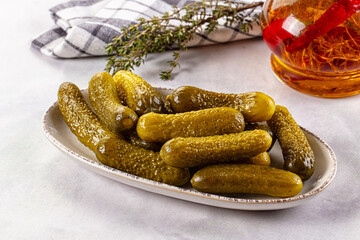 Marinated canned green cornichon cucumbers