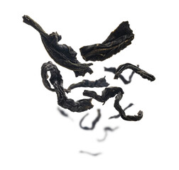 Dried black tea close up levitating on white background
