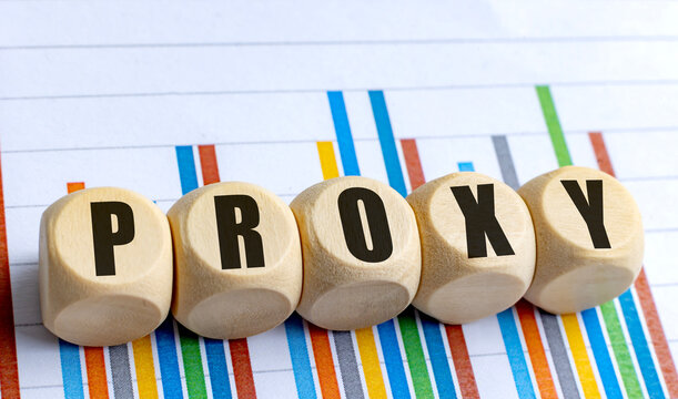 Wooden blocks with word proxy on colorful bar chart background representing financial or business concept