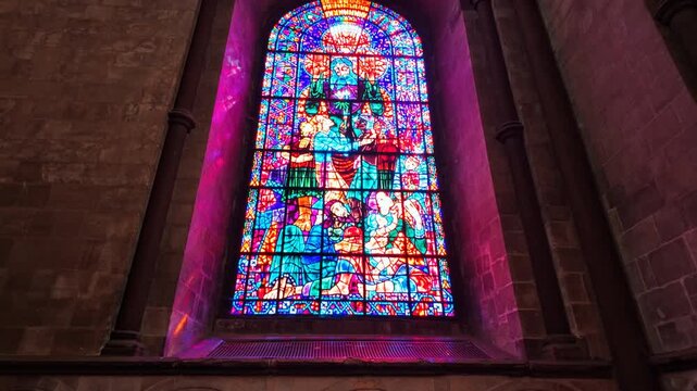 Stained glass inside Canterbury Cathedral, Kent, England, UK, UNESCO World Heritage Site, with vivid panes casting color across the nave