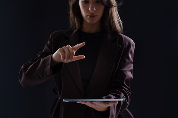 Businesswoman interacting with digital tablet using modern gestu