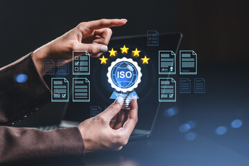 Hands holding glowing ISO certification icon with document icons and stars on dark gradient background, representing quality assurance concept.