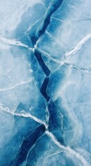 Obraz premium Frozen lake viewed from above showing cyan cracks and snow ripples in a clear blue ambiance