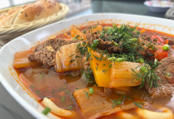 Chorba lamb soup, shurpa in Arabic restaurant. Kazakh meal with meat, spices and vegetables