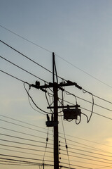 High voltage electric power lines and pylons against a blue sky