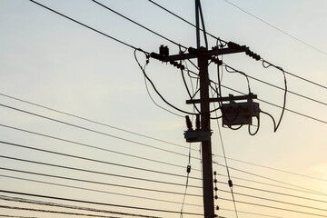 High voltage electric power lines and pylons against a blue sky