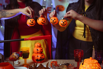 Asian man and woman celebrating Halloween, pumpkins at night, Halloween banner background for holiday activities.