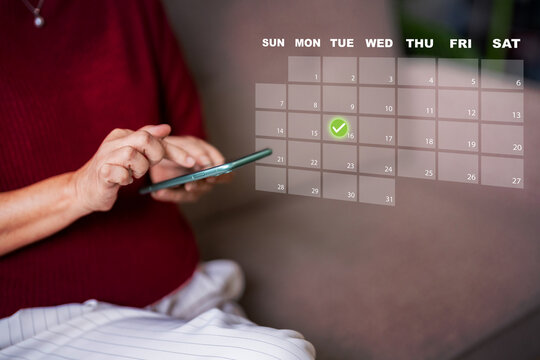 User managing personal schedule digital calendar booking appointment online smartphone application planning event confirming date modern technology interface