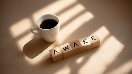 AWAKE wooden block coffee cup morning sunlight shadow caffeine motivation energy table concept positive start day drink hot beverage brown white inspirational alert fresh routine lifestyle