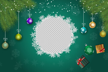 Christmas balls are hanging with snowflakes around a transparent central frame on green backdrop
