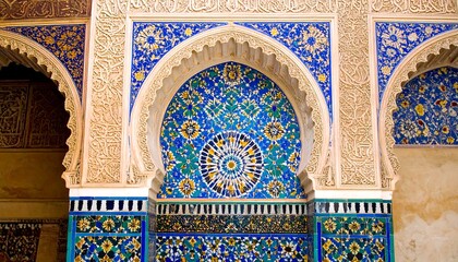 Ornate blue mosaic tilework in an arched alcove
