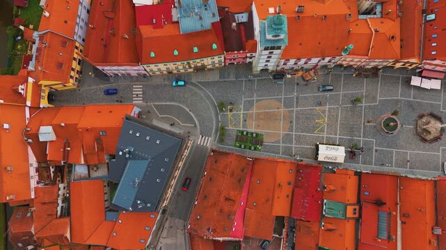 aerial drone view capturing the charming historic town square and surrounding red tiled rooftops of Třeboň, a picturesque spa town in the South Bohemian Region of the Czech Republic.
