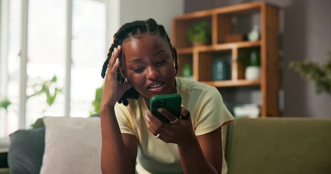 Upset woman, talking and phone call on sofa for conversation, gossip and speaking in living room. Stressed, black person and tech on couch with loudspeaker for contact, discussion and chat in home.